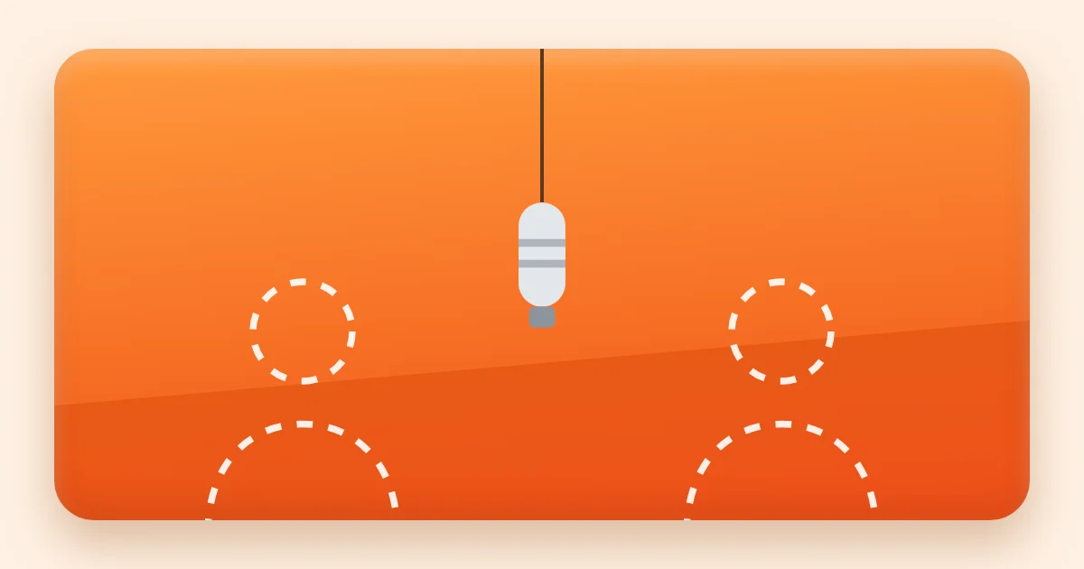 An orange studio booth with one microphone hanging between two empty spots